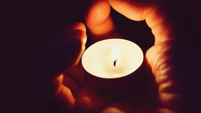candle light in a youth or adults hand symbolizing presence of the Holy Spirit