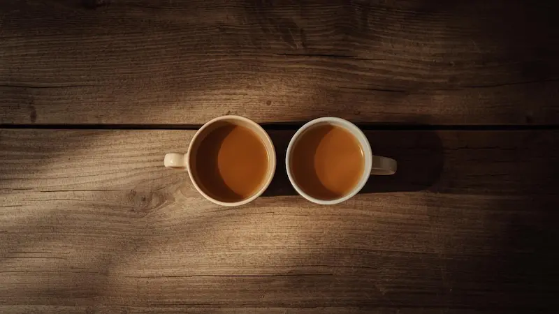 Two coffee mugs side by side on a table