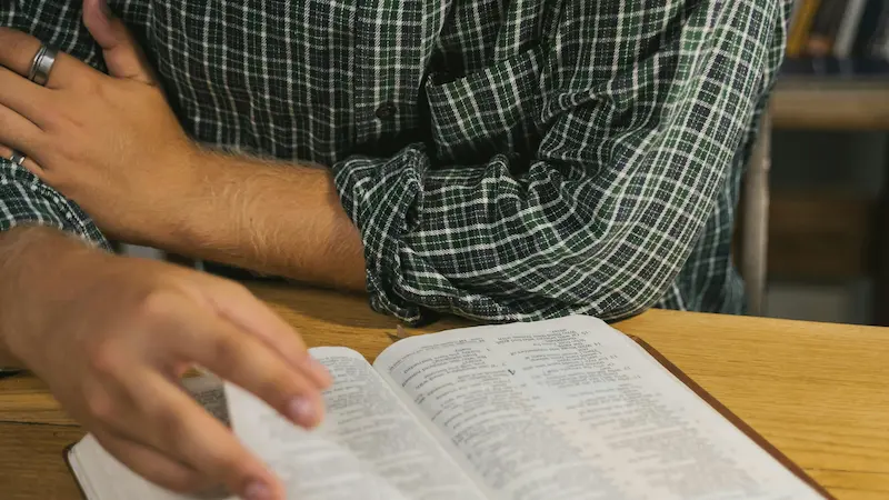 A person studying the Bible to understand the nature of sin.