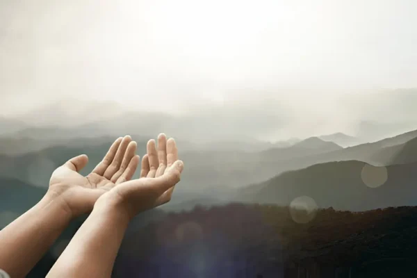 “Person praying while fasting during sunrise”
