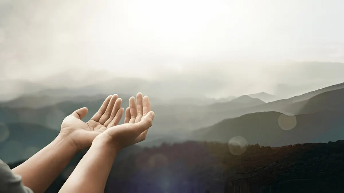 “Person praying while fasting during sunrise”