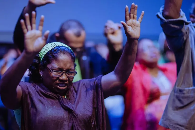 Person worshiping, symbolizing the baptism and fire of the Holy Spirit