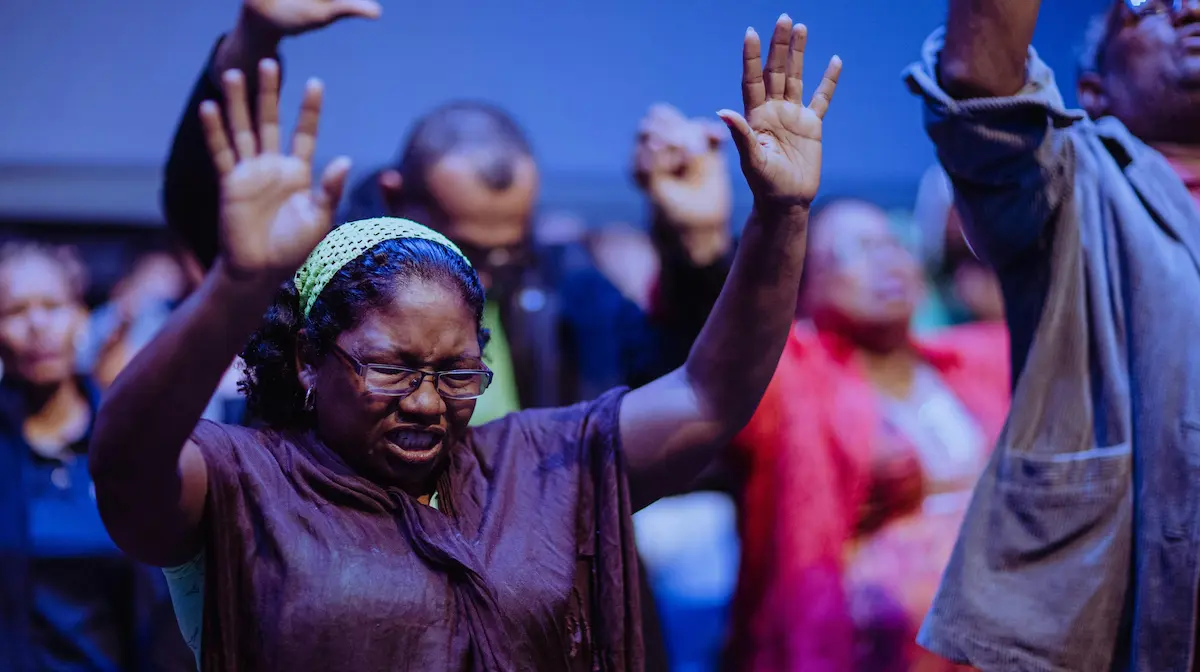 Person worshiping, symbolizing the baptism and fire of the Holy Spirit