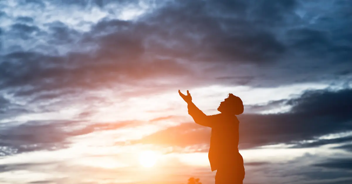 “Young person lifting hands in worship, symbolizing encounter with the Holy Spirit”