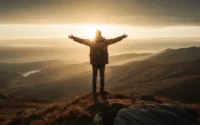 "Person standing on a mountain peak with arms raised in worship and victory, embracing God’s presence"