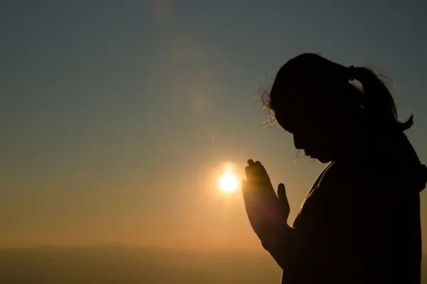 Christian praying at sunrise for divine breakthrough”