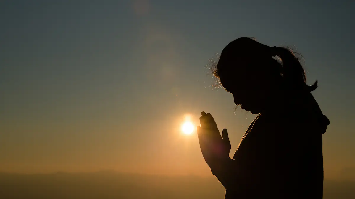 Christian praying at sunrise for divine breakthrough”