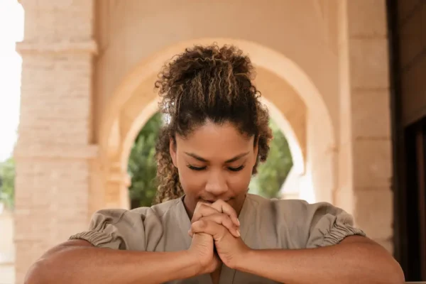 “Finding peace through prayer in quiet reflection.”
