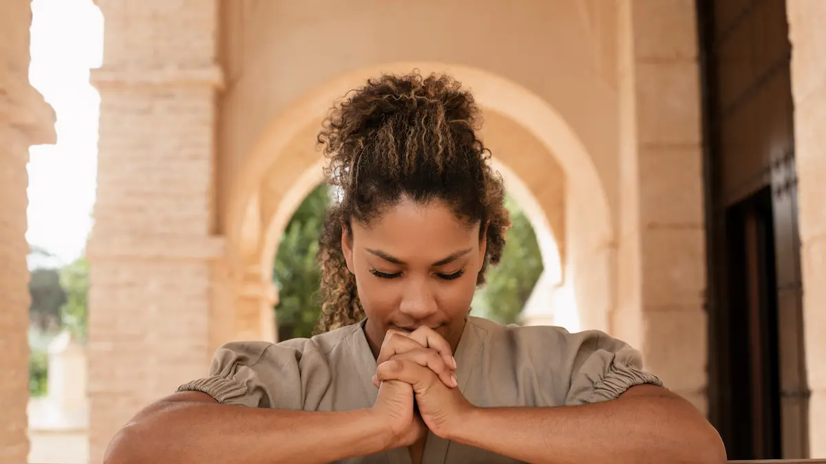 “Finding peace through prayer in quiet reflection.”