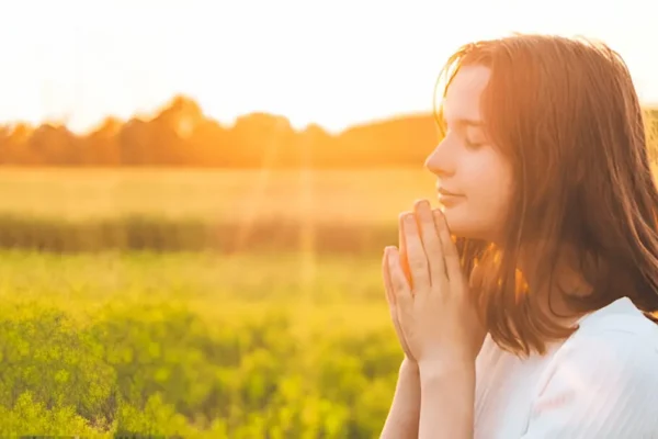 Believer kneeling in prayer at dawn, symbolizing readiness for Christ’s return.