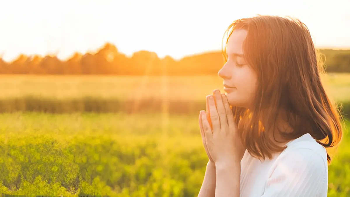 Believer kneeling in prayer at dawn, symbolizing readiness for Christ’s return.
