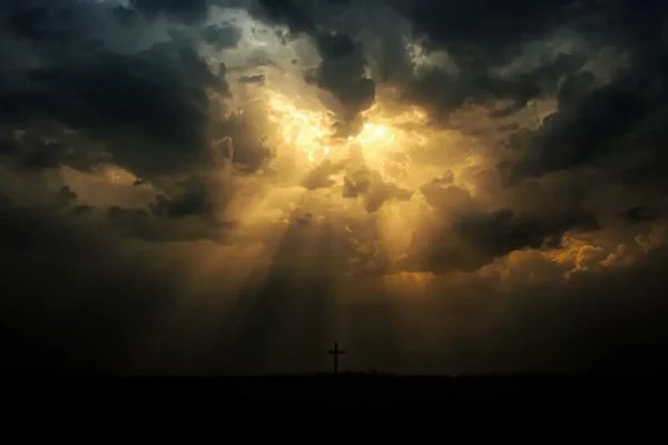 Storm clouds with rays of light breaking through, symbolizing the hope and mystery of end times prophecy from the Bible.