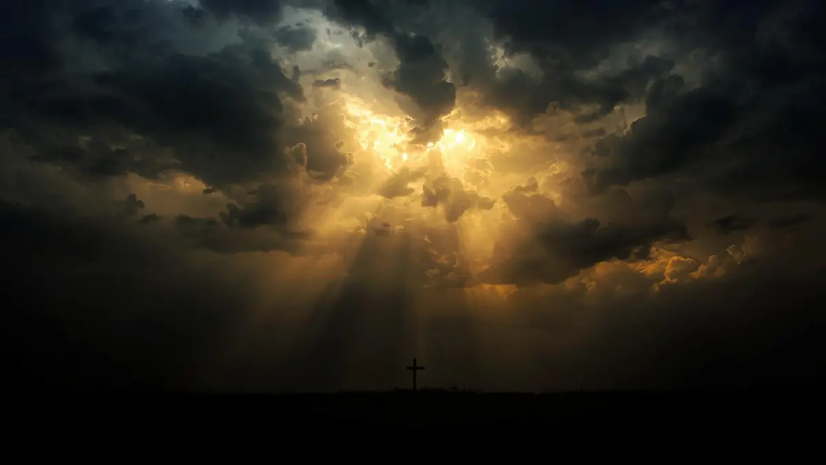 Storm clouds with rays of light breaking through, symbolizing the hope and mystery of end times prophecy from the Bible.