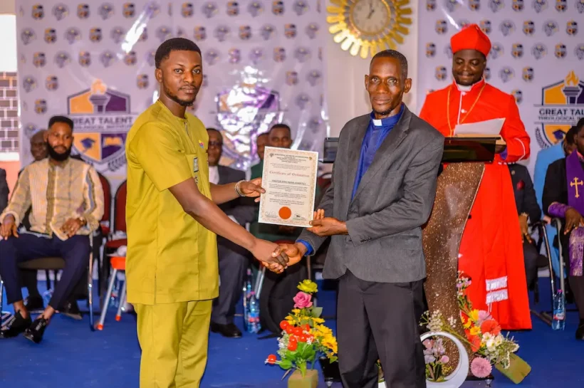 Apostle Isaac Rockefeller Asamoah presenting a certificate to a ministerial graduate