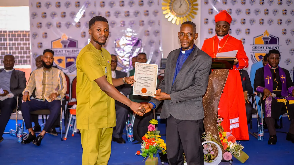 Apostle Isaac Rockefeller Asamoah presenting a certificate to a ministerial graduate